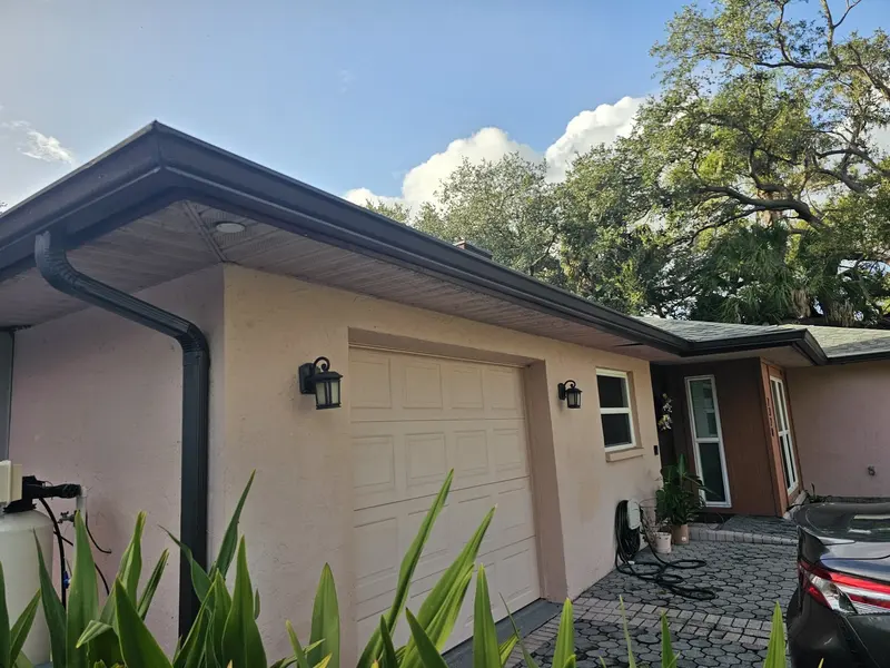 Bronze seamless gutter and downspout on a salmon stucco home