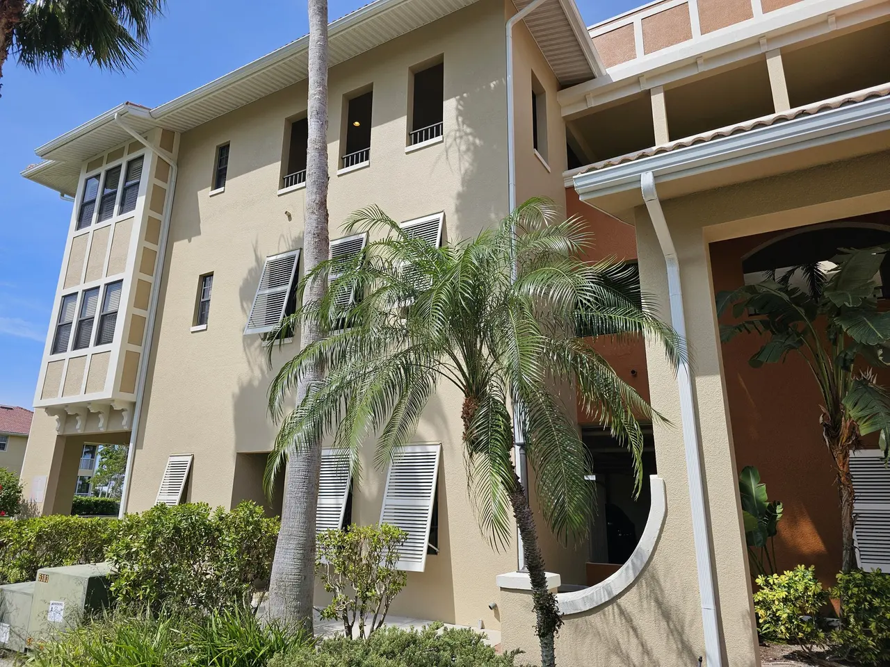 Seamless gutter along a two-story townhome with a paver driveway