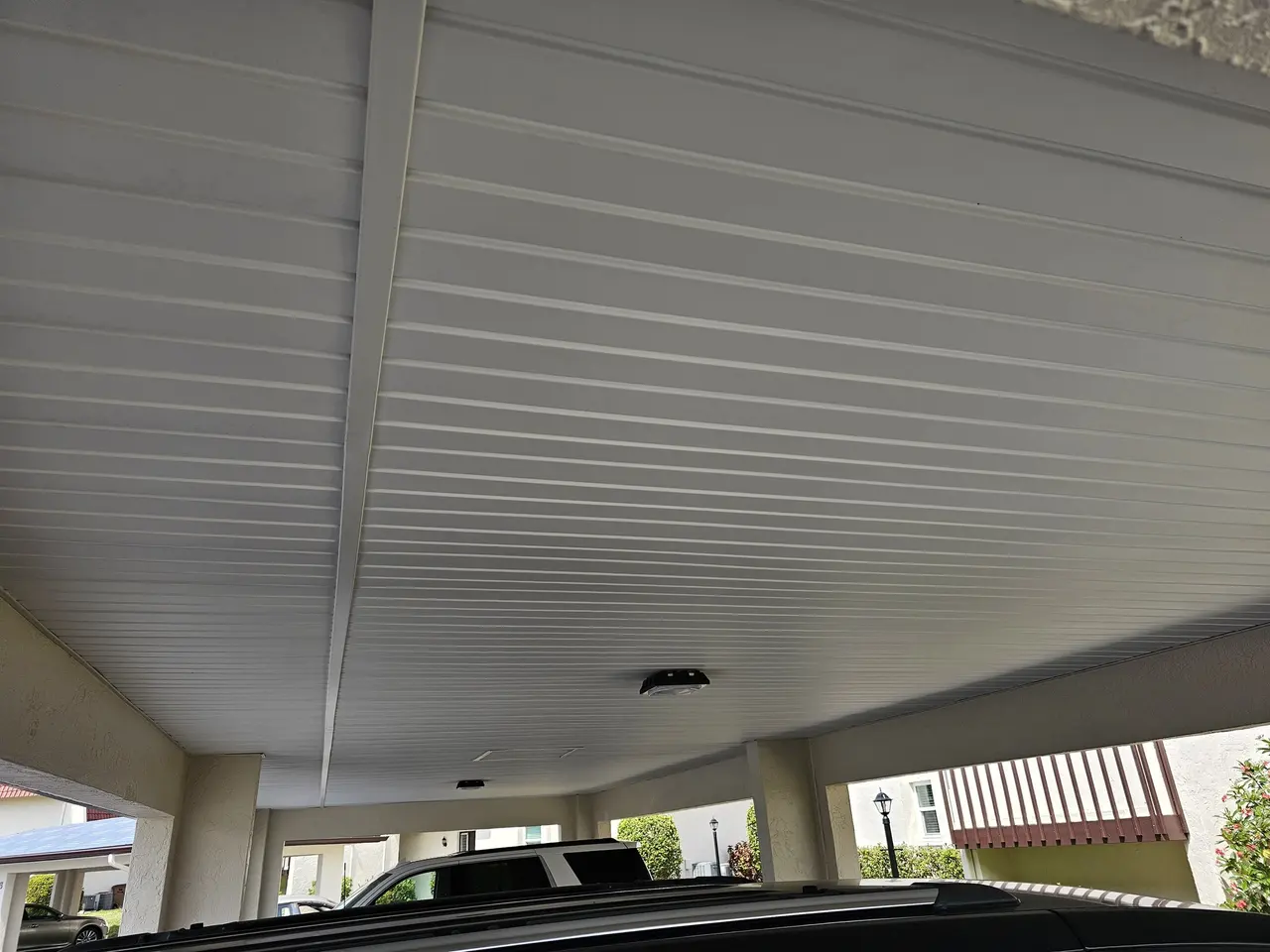 Underside of a carport roof with the new gutter edge