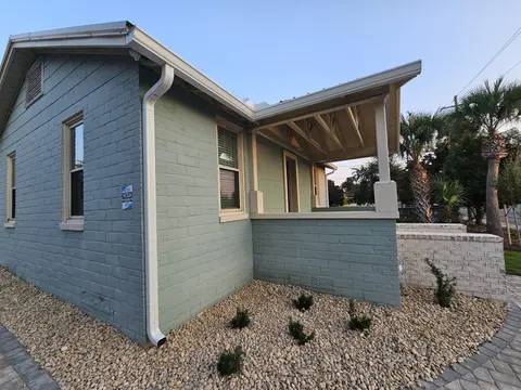 New two-story home with white seamless gutters and a covered porch